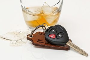 broken glass of alcohol with car keys 